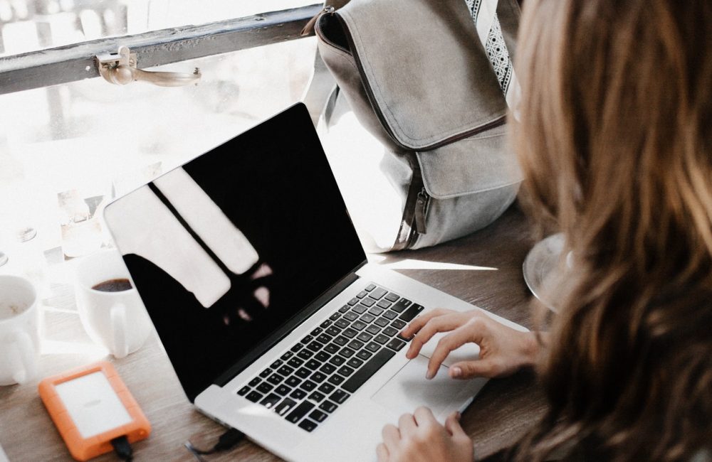 close-up-photography-of-woman-sitting-beside-table-while-3178818